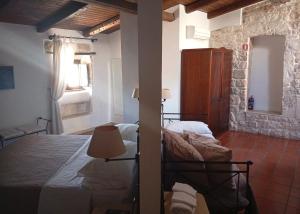 a bedroom with a bed and a lamp in a room at Hotel Corte Altavilla in Conversano