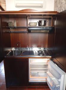 an empty kitchen with a sink and a stove at Hotel Corte Altavilla in Conversano