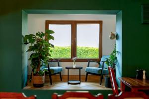 a room with chairs and a window and a table at Szept Beskidów in Milówka
