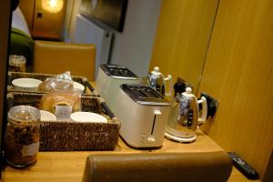 a table with two toasters on top of it at Eryri Golden Stays in Capel Garmon