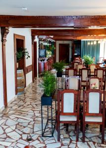 a restaurant with chairs and tables in a room at Szept Beskidów in Milówka