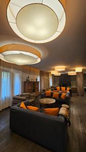 a large living room with couches and tables at Aparthotel Siente Boí & SPA in Pla de l'Ermita