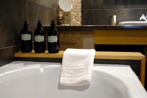 a bathroom with two bottles of wine on a sink at Eryri Golden Stays in Capel Garmon +45 photos