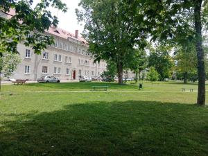 a park with benches in front of a large building at Apartament Glamour Chełm in Chełm