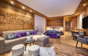 a living room with a couch and a bed at Panorama Alm in Jochberg