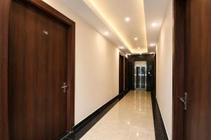 a corridor with a door and a hallway with a window at FabHotel Durga Luxury Studio in Gurgaon