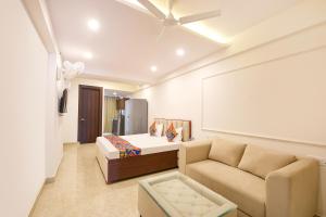 a living room with a bed and a couch at FabHotel Durga Luxury Studio in Gurgaon