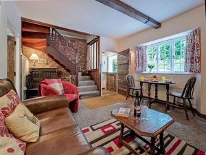 a living room with a couch and a table at Ruffles Cottage Dunster in Dunster