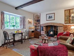a living room with a couch and a fireplace at Ruffles Cottage Dunster in Dunster