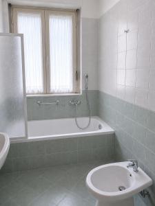 a bathroom with a tub and a toilet and a sink at In Piazza Pompeii in Pompei