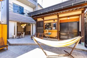 a hammock on the patio of a house at UG HOSTEL Takayama in Takayama