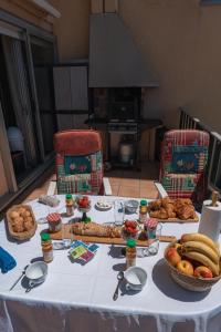 a table with food on it with two chairs at Le Lydia - Duplex - Vue Mer - Accès direct Plage - Parking - Barbecue in Le Barcarès