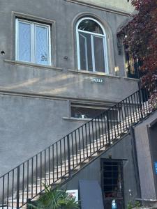 a building with a staircase leading up to a window at Dvali in Tbilisi City