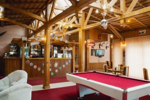 a billiard room with a red pool table at Hotel Korona in Siófok