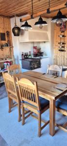 a wooden dining table and chairs in a kitchen at Monis und Marcos B&B in Koppom