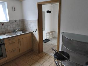 a kitchen with a sink and a door to a room at Manni's Home in Munderkingen
