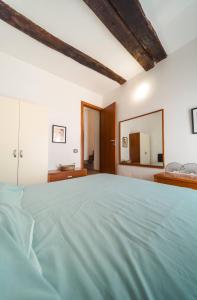 a bedroom with a large bed with a large mirror at Malù Cozy Borgo Retreat in Casperia