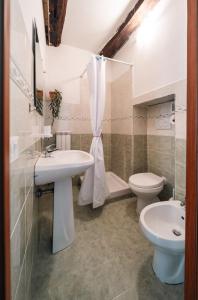 a bathroom with a sink and a toilet at Malù Cozy Borgo Retreat in Casperia