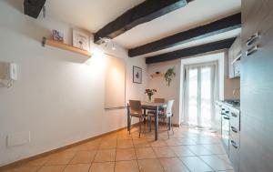 a kitchen and dining room with a table and chairs at Malù Cozy Borgo Retreat in Casperia