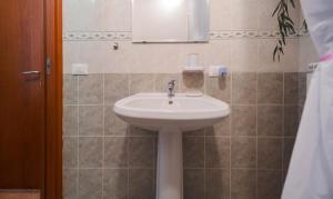a bathroom with a white sink and a mirror at Malù Cozy Borgo Retreat in Casperia +17 photos
