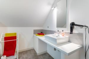 a bathroom with a white sink and a mirror at Entre mer et rivière in Moëlan-sur-Mer +33 photos