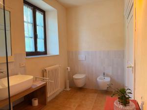 a bathroom with a sink and a toilet at Kiki's Langhe House in Castagnole Lanze +16 photos