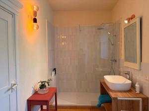 a bathroom with a shower and a sink and a toilet at Kiki's Langhe House in Castagnole Lanze