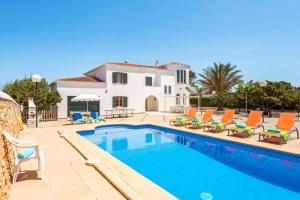 a villa with a swimming pool in front of a house at Villa Xabec by Villa Plus in Cala en Blanes