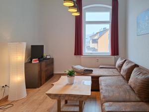 a living room with a couch and a table at Haus Felsenpost in Stadt Wehlen