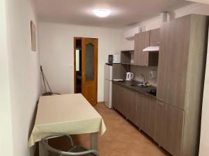 a small kitchen with a table and a counter top at Panoráma Szálláshely in Csongrád
