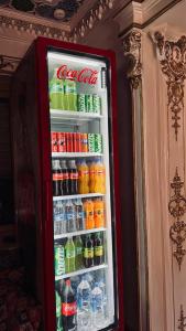 a red refrigerator filled with soda and sodas at SILVER Inn in Bukhara
