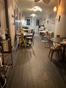 a restaurant with tables and chairs in a room at L Entre Deux chambres d hôtes in Belin-Beliet