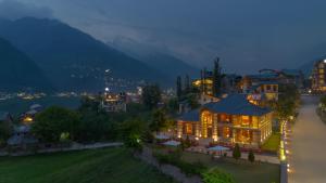 a building with lights on in a city at night at Padma Villa - Mountain Estate in Manali in Manāli