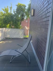 a chair sitting on a patio next to a brick wall at Lingen Stay 2 in Lingen