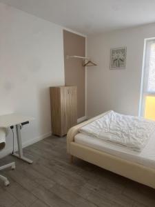 a bedroom with a bed and a desk and a table at Lingen Stay 2 in Lingen