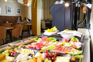 a buffet line with many different types of food at Hotel Schillerbad in Lüdenscheid +7 photos