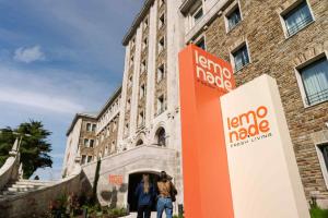 two people are standing in front of a building at Lemonade Stays Santiago de Compostela in Santiago de Compostela