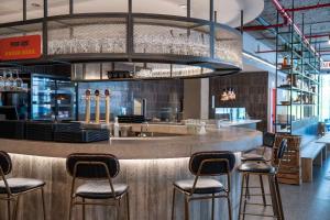 a bar in a restaurant with bar stools at Lemonade Stays Santiago de Compostela in Santiago de Compostela