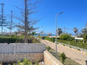 a brick retaining wall next to a sidewalk with a street light at chalet ramsis village in Alexandria