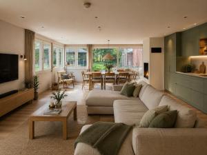 a living room with a couch and a table at Heidhof in Bispingen