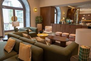 a living room with a couch and chairs and a table at Lemonade Stays Santiago de Compostela in Santiago de Compostela
