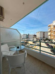 a balcony with a table and chairs and a view of a city at The Rock Apartments in Himare