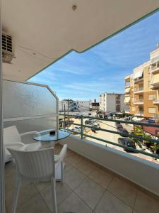 a balcony with a table and a view of a city at The Rock Apartments in Himare