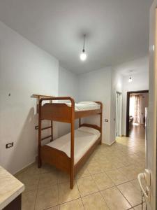 a room with two bunk beds in a kitchen at The Rock Apartments in Himare +9 photos