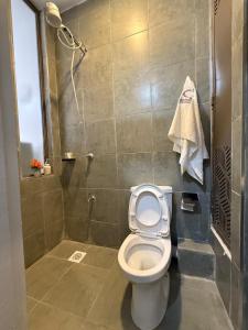 a bathroom with a toilet and a shower at Tsavo in Kiambu