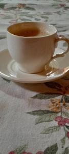 a cup of coffee sitting on a plate on a table at MANN House in Ninkovići +43 photos