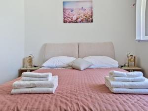 a bedroom with a bed with towels on it at Holiday Home Rudi by Interhome in Kraj