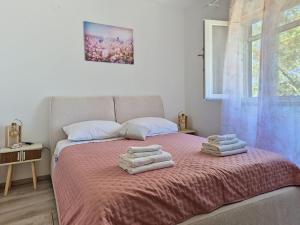 a bedroom with a bed with towels on it at Holiday Home Rudi by Interhome in Kraj