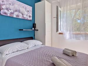 a bedroom with a bed with a blue wall at Holiday Home Rudi by Interhome in Kraj +34 photos