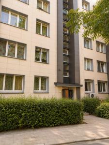 a tall building with bushes in front of it at Nemunas in Panevėžys +4 photos